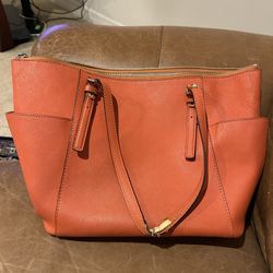 This is an orange Michael Kors tote bag