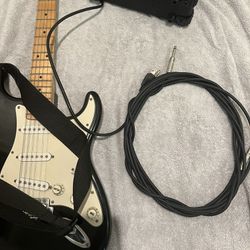 starcaster electric guitar with amp and strap