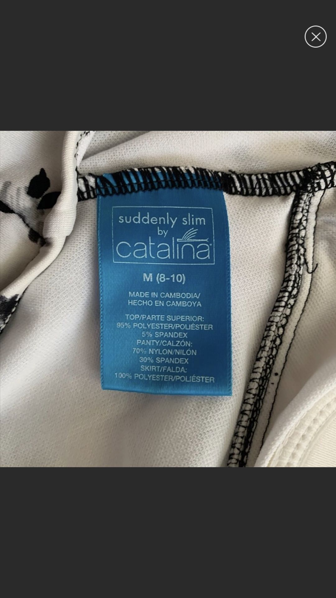 Two piece suit flowery white with black flowers very flattering by Catalina namebrand suddenly slim size medium New Like Condition