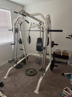 Home gym / Smith machine with weights and bench.