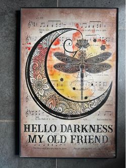decorative print features a dragonfly and crescent moon design overlaid on sheet music for "The Sound of Silence