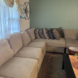 Used sofa in a brownish-beige herringbone fabric.