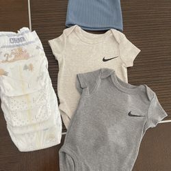 Two NIKE Onesies with hat,five Huggies diapers (size 1)