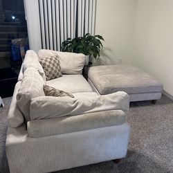 Off white couch with extendable back rests and foot sectional