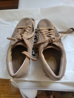 A pair of shoes brand MICHAEL KORS