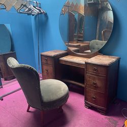 Vanity with round mirror and chair