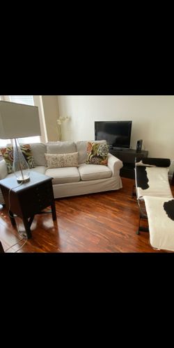 Living room set. Pottery Barn sofa, cowhide lounger, PB board game table, glass lamp