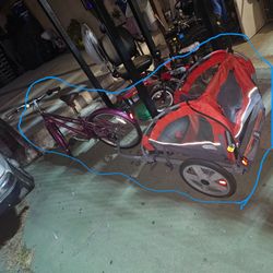 Women bike with two kids wagon