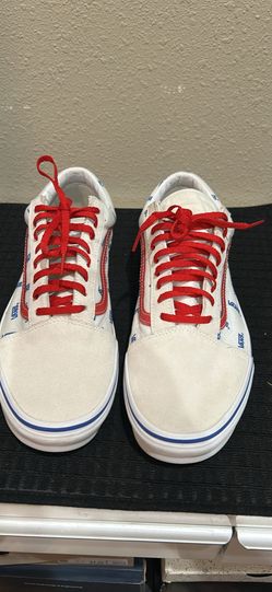 Vans Old Skool sneakers featuring a white and blue logo print upper and red laces. Size 12 $50