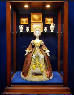 Russian Tzarina porcelain doll featuring a pink and gold brocade dress and an elaborate headpiece. 10" Tall