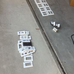 white plastic electrical wall plates, also known as switch plates or outlet covers And Switches 