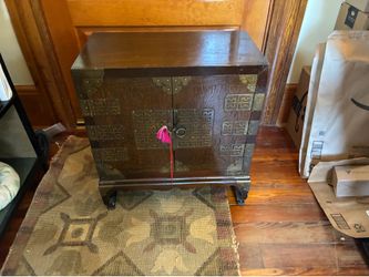 Two Asian influenced side storage tables.