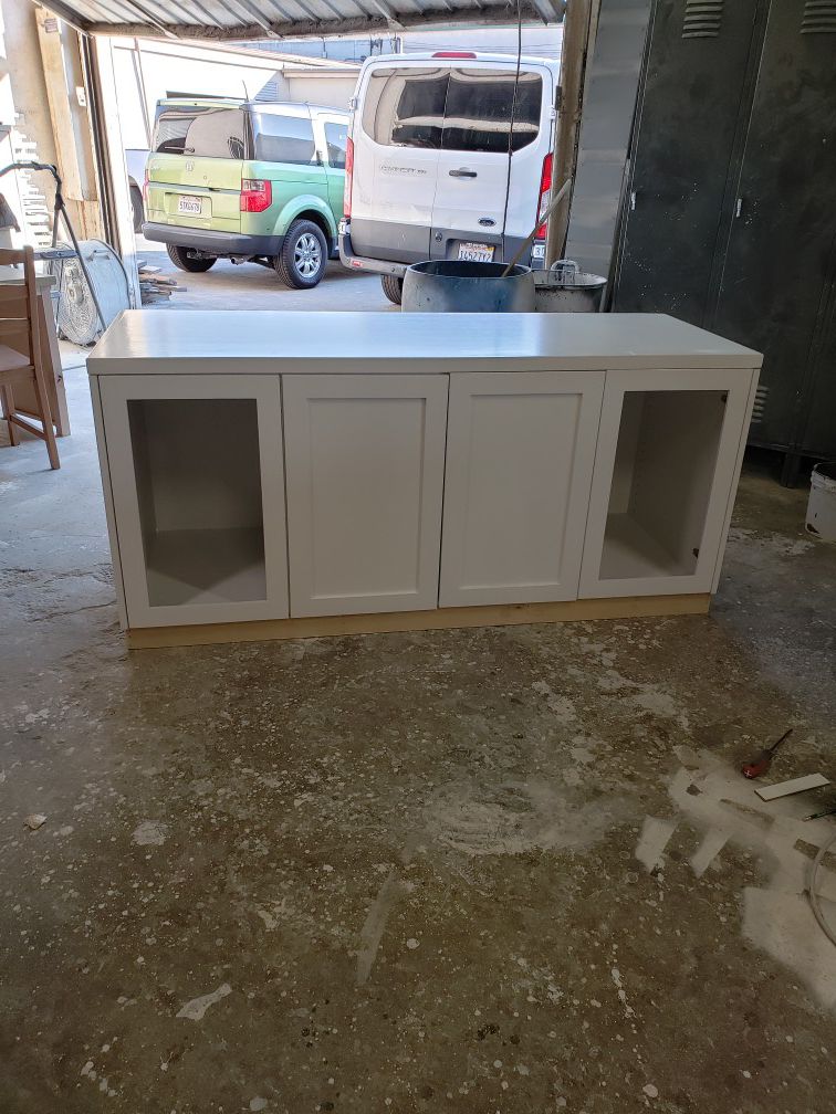 Plywood and solid wood cabinets, finish white lacquer , new never used, w 68.5 d 25 and h 32..