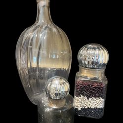 A set of three vintage ribbed glass decanters and canisters with fluted stoppers.