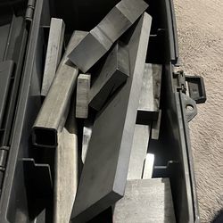 Small toolbox with machinist blocks and pieces of aluminum