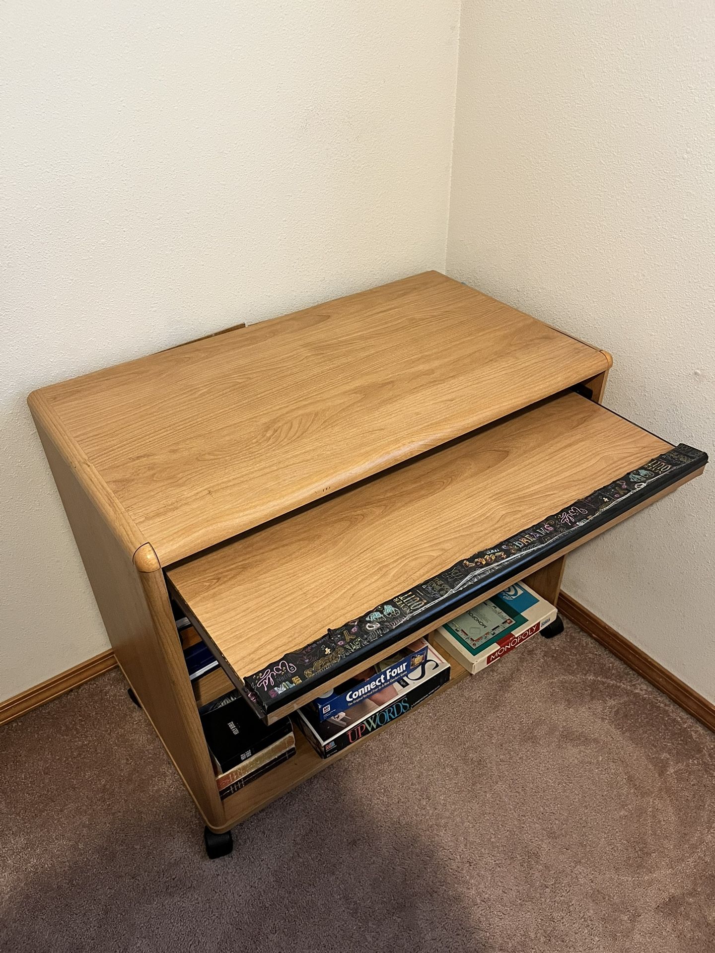 wheeled table with storage shelves and a rolling keyboard platform