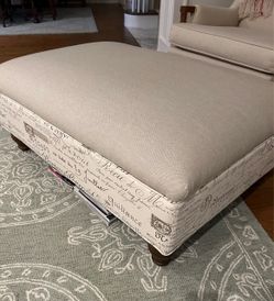 NEW! Upholstered Ottoman with Neutral Linen and French Script Print and beautiful turned wooden legs