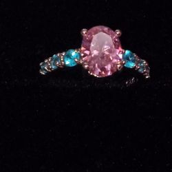 pink gemstone and blue topaz ring