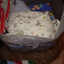 Grocery bag full of baby boy clothes