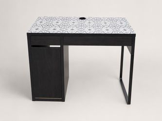 IKEA Black desk with decorative surface, drawer, and side storage