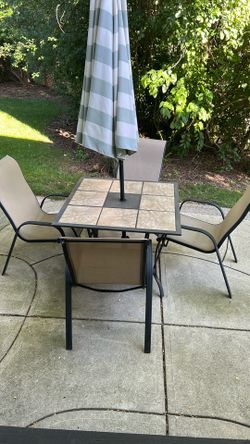 Patio table with umbrella and chairs