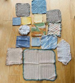 Collection of hand crocheted, knitted, embroidered hot pads, dollies, cloth. Various sizes and colors, 24 pieces total.