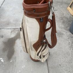 vintage Hogan golf bag, specifically an AMF Hogan model. This classic bag features a traditional design with tan canvas and brown leather accents.