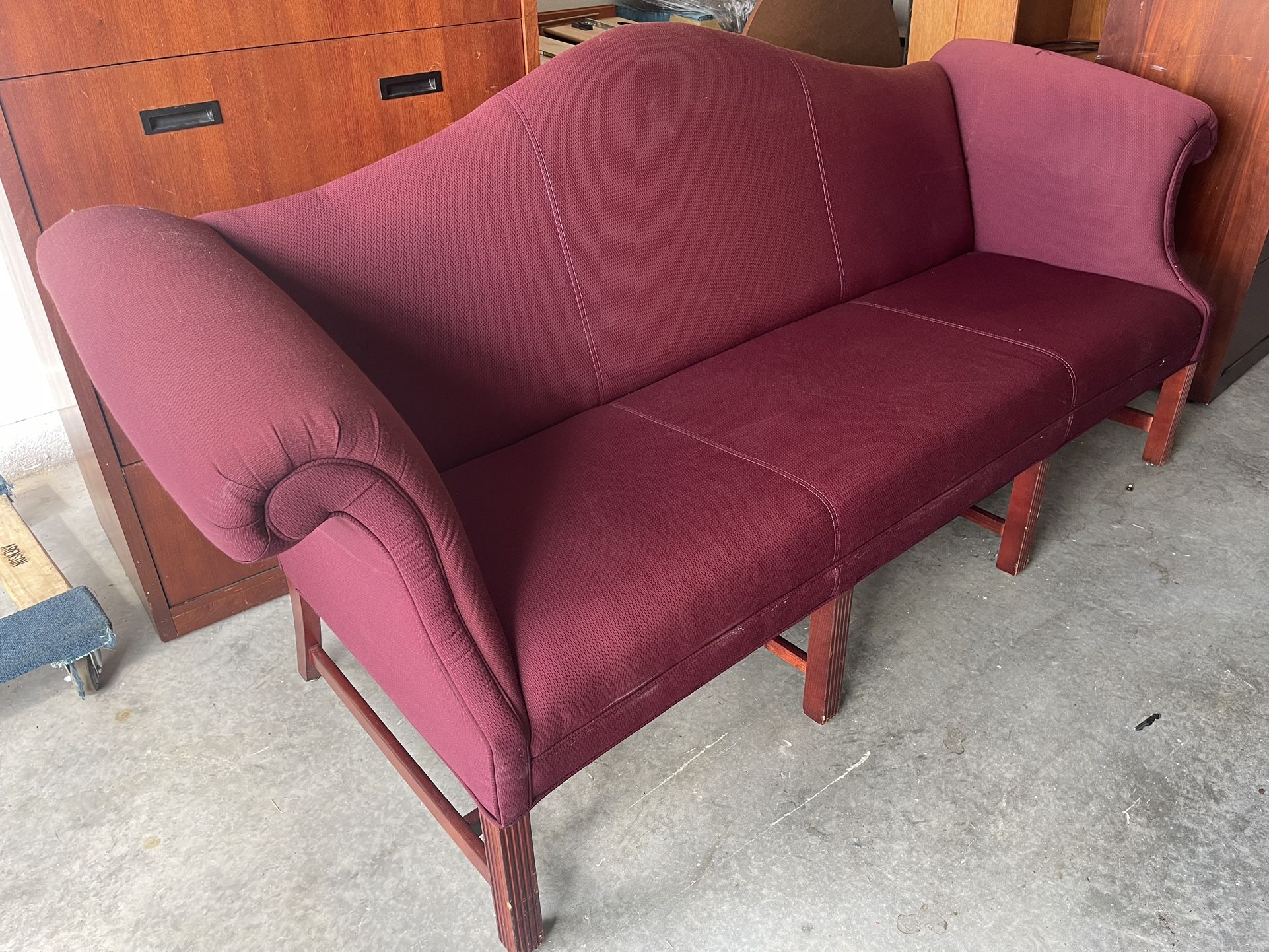 Burgundy polyester-upholstered loveseat, seats up to 3 people.