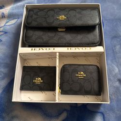 Coach signature monogram 3-piece set in black, featuring a shoulder bag, wallet, and card case.