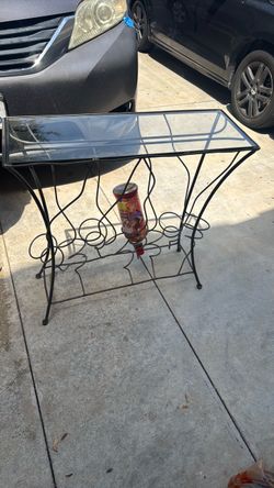 Glass and metal table with wine bottle display bottome