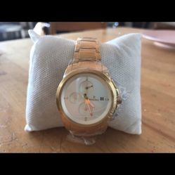 Round gold colored analog watch with linked bracelet