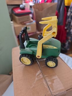John Deere toy tractor with a front-mounted hay fork loader