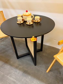 Round Black Dining Table with Rattan Base
