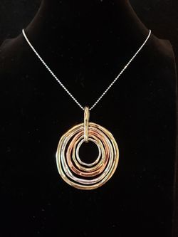 $10. Beautiful silver and gold tone circular necklace. 28 inches. 2 1/4 inch long and 1 3/4 inch wide.