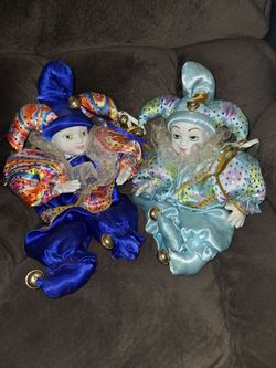 Sitting harlequin dolls