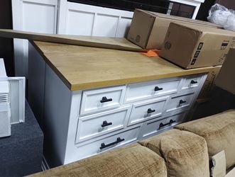 Dresser features a white finish with a butcher block top and modern farmhouse-style black hardware.