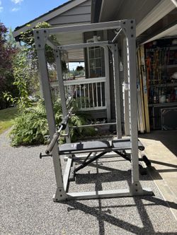 Olympic weights with Smith Rack, tricep bar, weight bench and Olympic plate rack