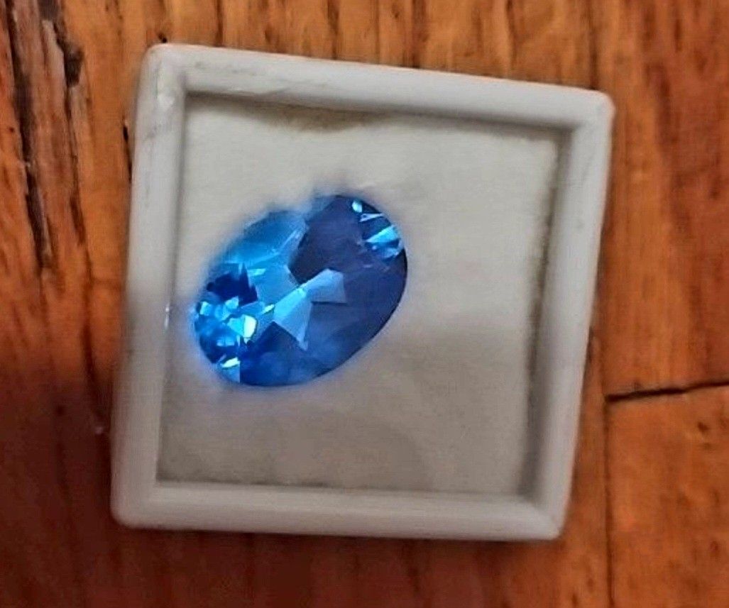 Oval-shaped blue topaz gemstone