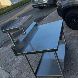 Stainless steel Table with underneath space and top shelf   $375  48 x 30 table  24 x 12 shelf 