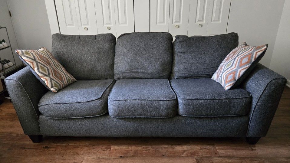 Gray Three-Seat Sofa with Pillows