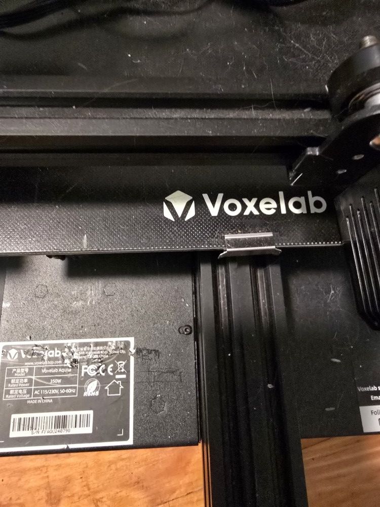Voxelab Aquila 3D Printer With Black Filament.