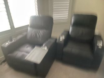 Two black leather lounge chairs