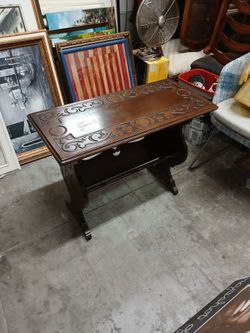 carved wooden side table magazine rack