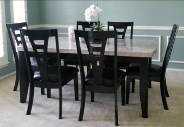 Granite top dining table with 6 chairs included. 72" L x 42" W x 30.5" H.