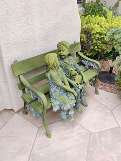 Outdoor bronze statue boy girl dog