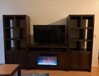 Entertainment center with fire place and TV