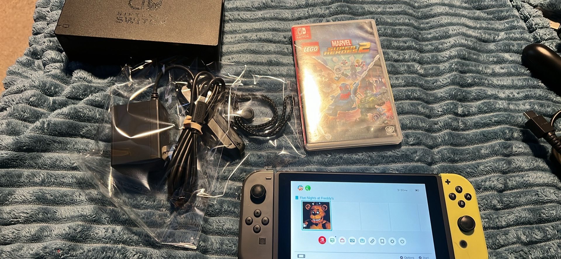 Nintendo switch with docking station and marvel super hero’s 2 game