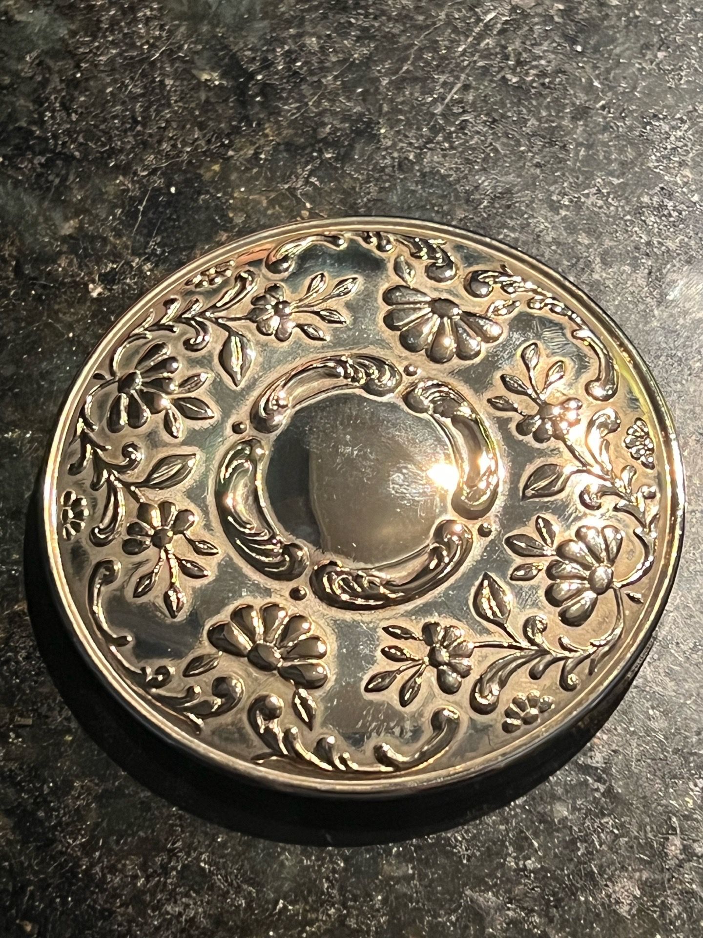 This is a vintage Princess House silverplated purse mirror featuring an ornate repousse floral design