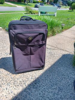 Brown luggage 27 tall by 16 and a half wide