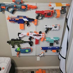 12 NERF, pegboard, and extra clips and pegs